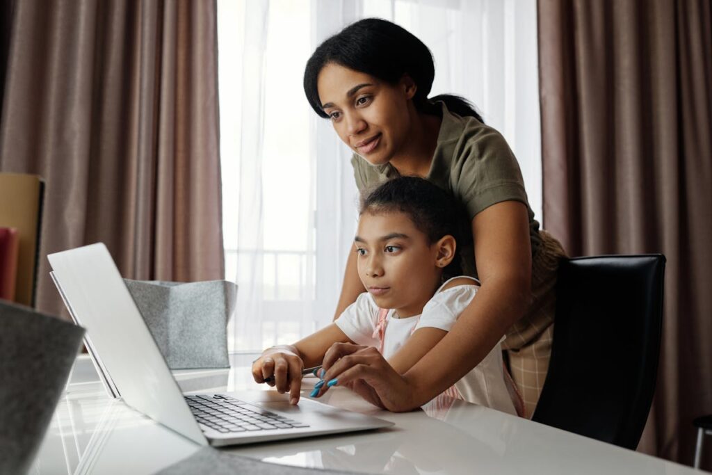 pexels-photo-4260325 Mother Helping her Daughter use a Laptop